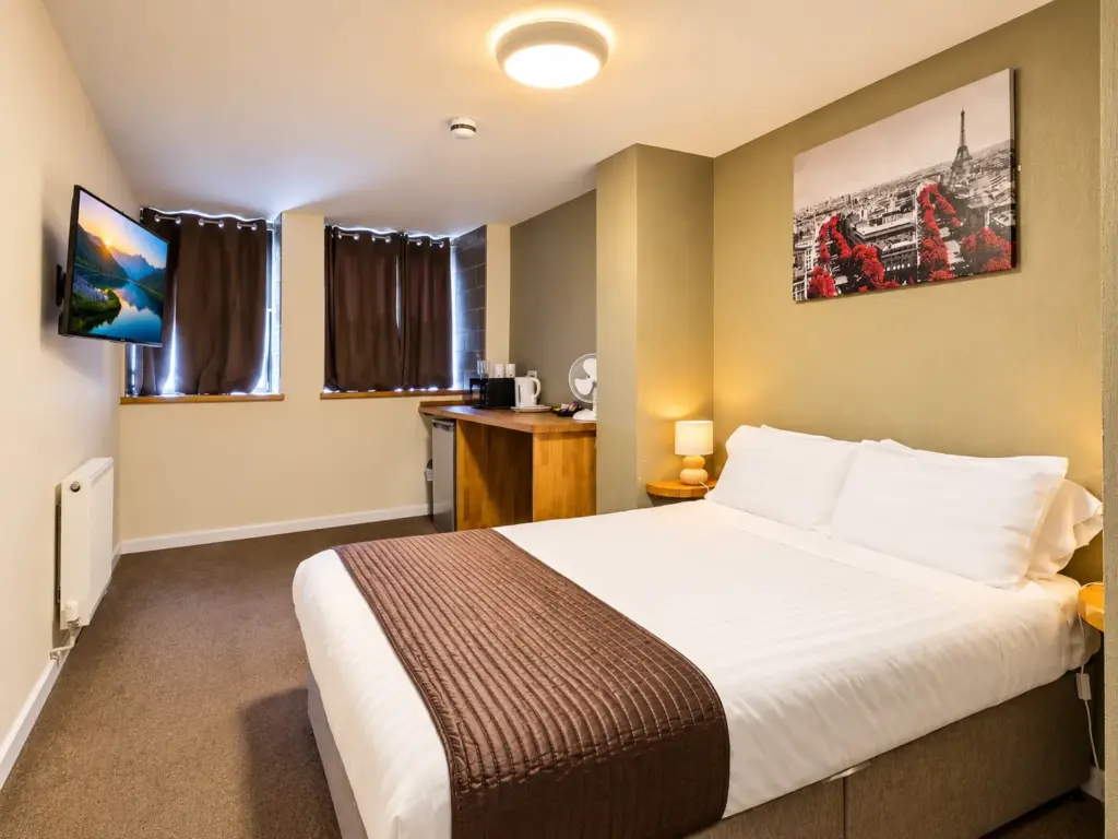 Cozy Modern Hotel Room with Paris Artwork